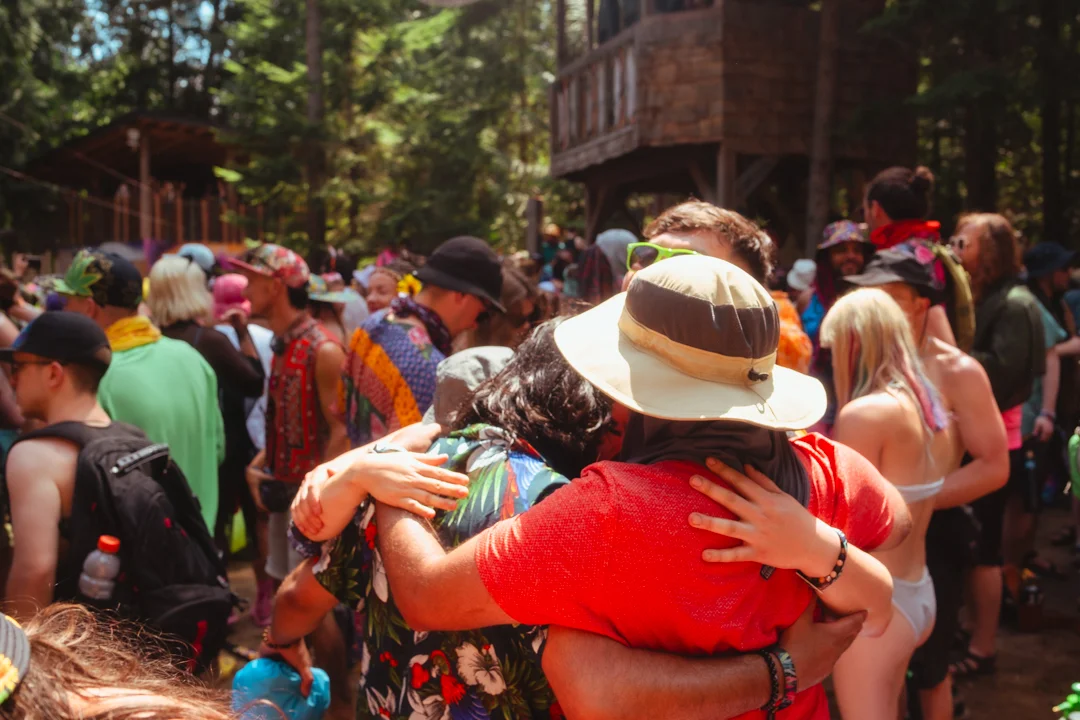 friends hugging, so happy to be together and a part of Shambhala Music Festival during the 2023 event last july.