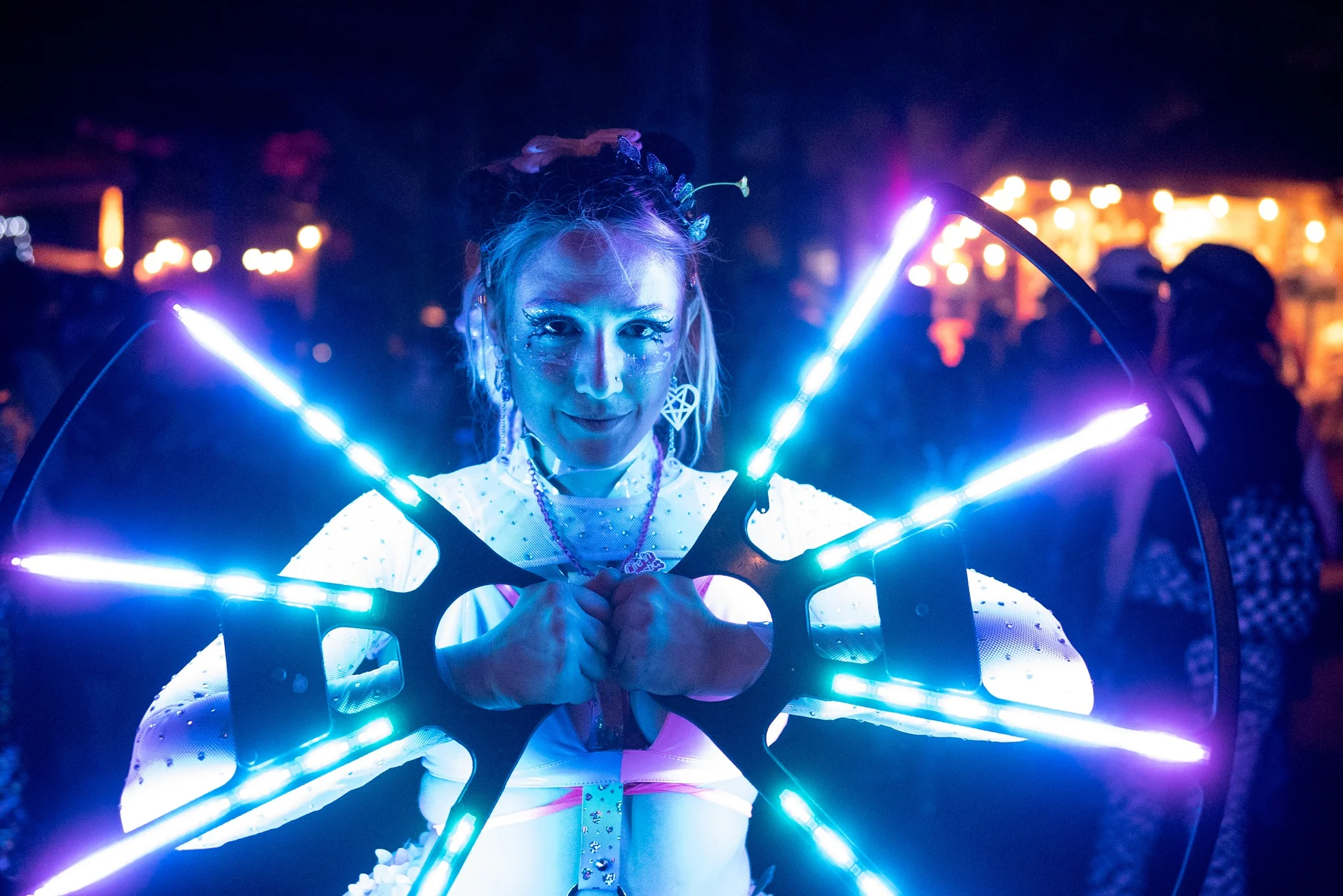 music festival patron with an intricate light poi, dancing to the beats of Shambhala Music Festival 