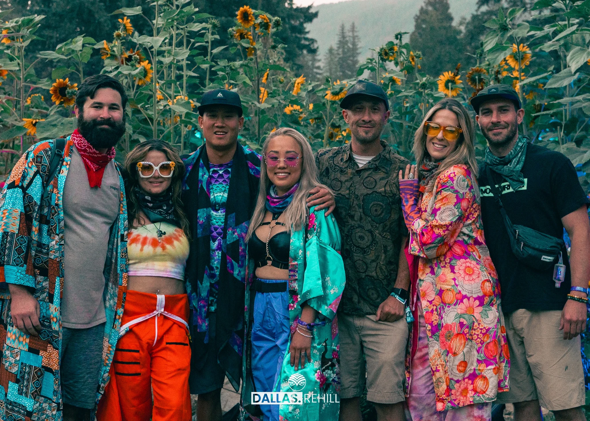 Shambhala 2023 Farmily loving the eves of the Sunflower garden at the farm in colorful outs and embracing