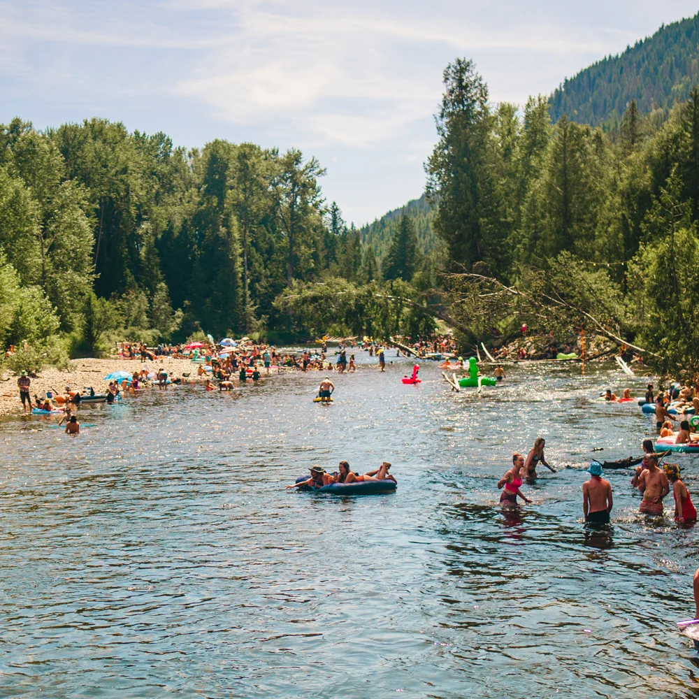 The river at Shambhala Music Festival where people are swimming and on floaties during the dance festival.