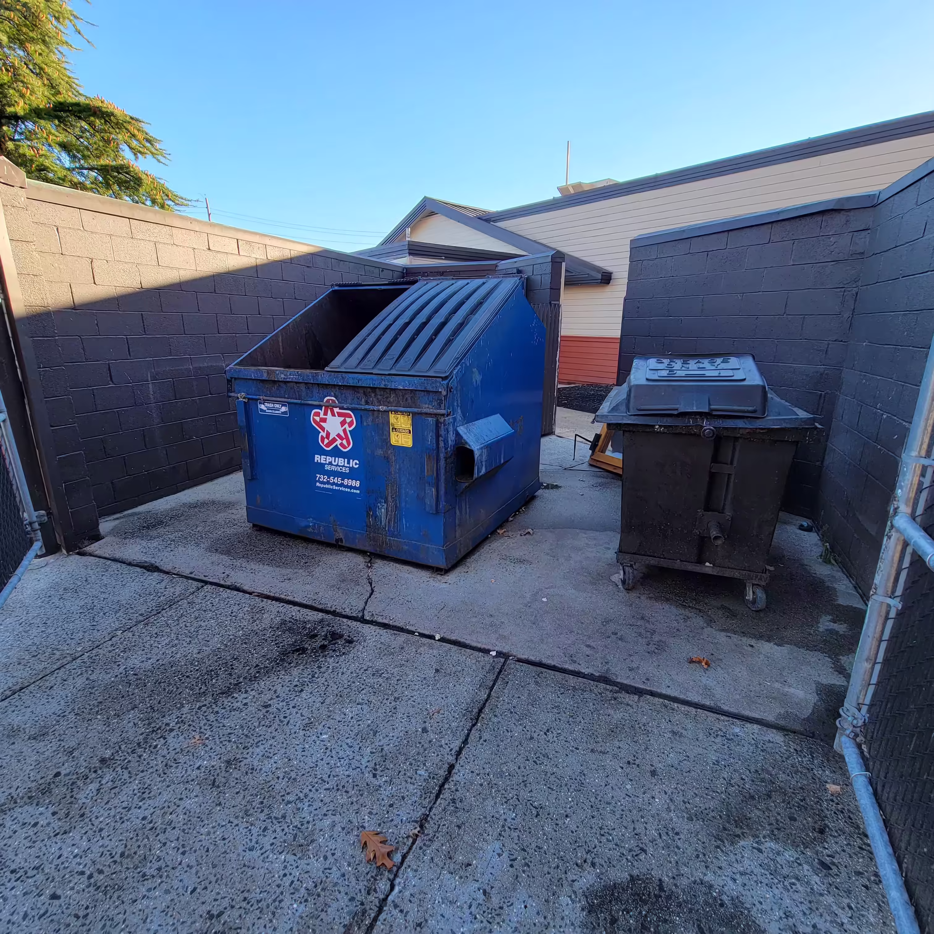 EEC sanitizing a dumpster enclosure in NJ