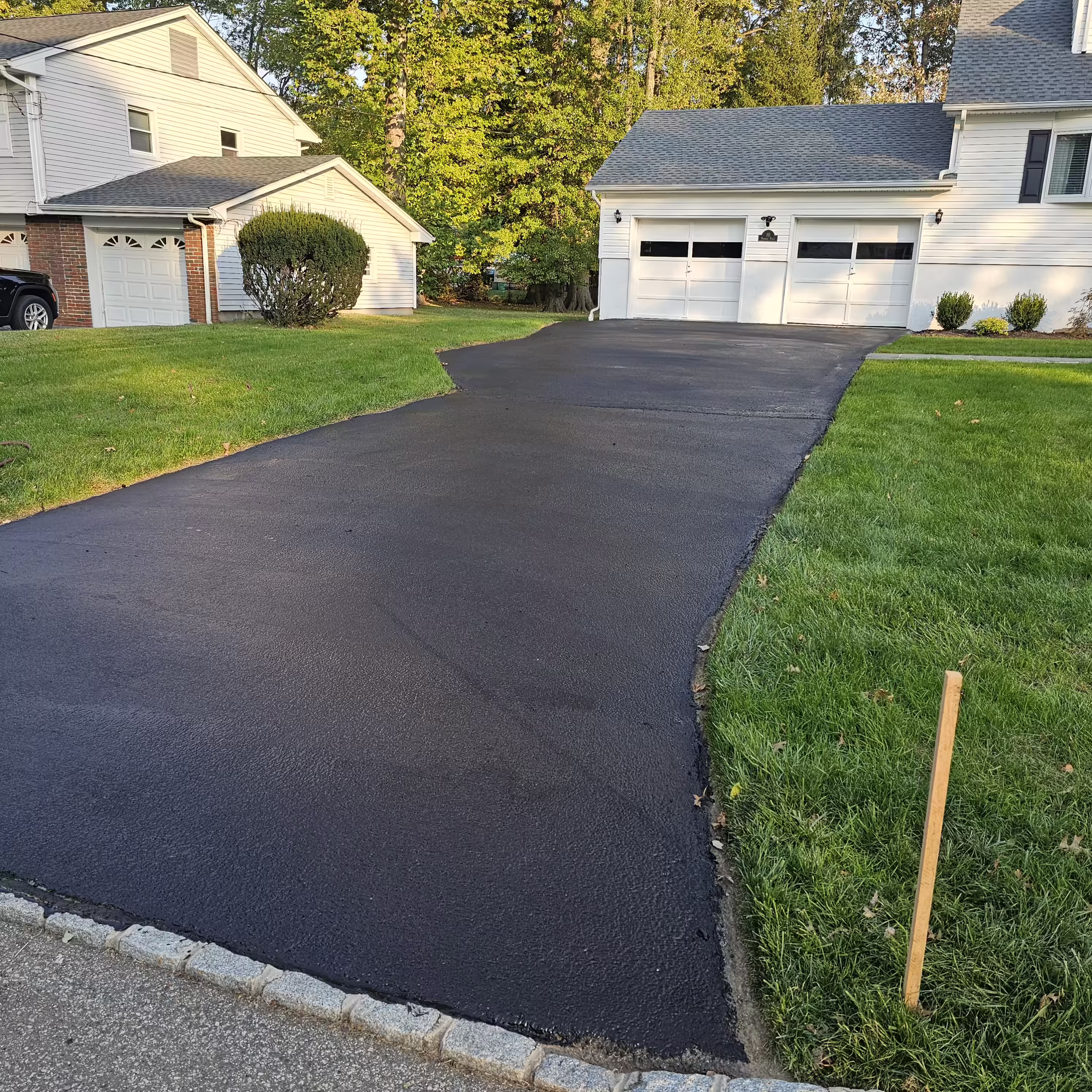 Fresh asphalt sealcoating on a NJ driveway