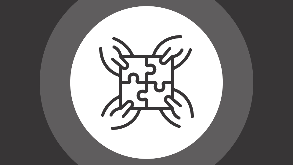 Icon of four hands each holding one piece of a four-piece puzzle fitting together in a white circle against a gray background.