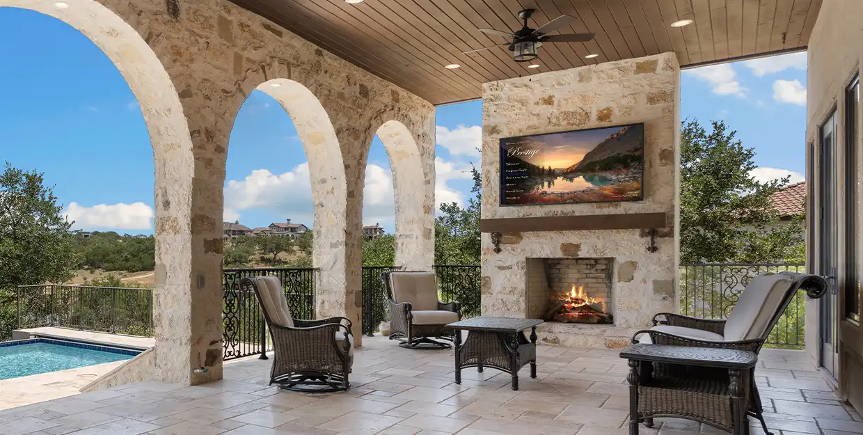Outdoor hotel patio with an outdoor TV showcasing the hotel's custom TV theme.