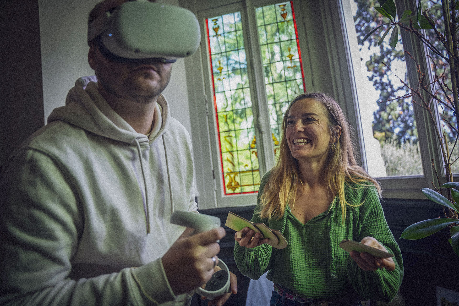 Colleagues playing a virtual reality game during a team-building activity at Château des Forges