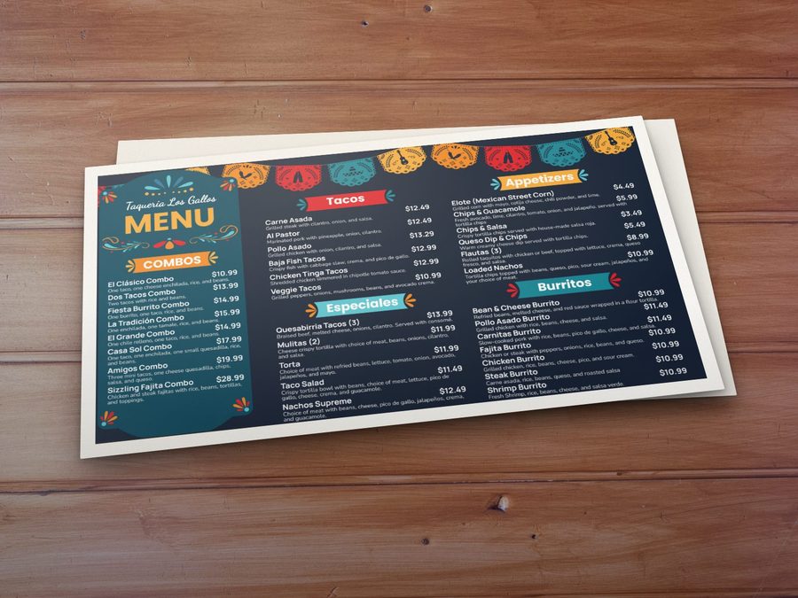 A printed taqueria menu on a table, in the same design as the menu board