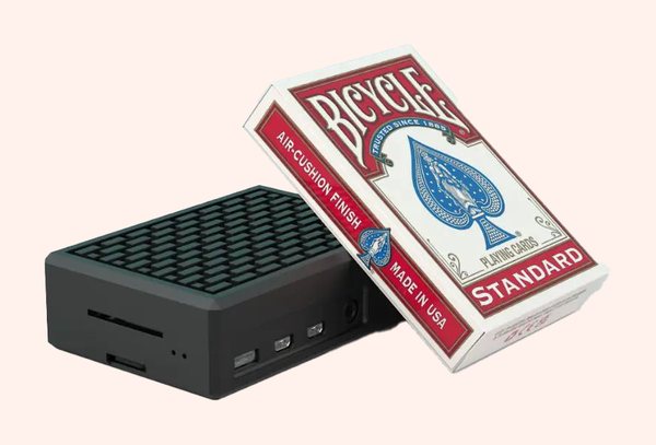 A JAM Player next to a pack of playing cards, for size
