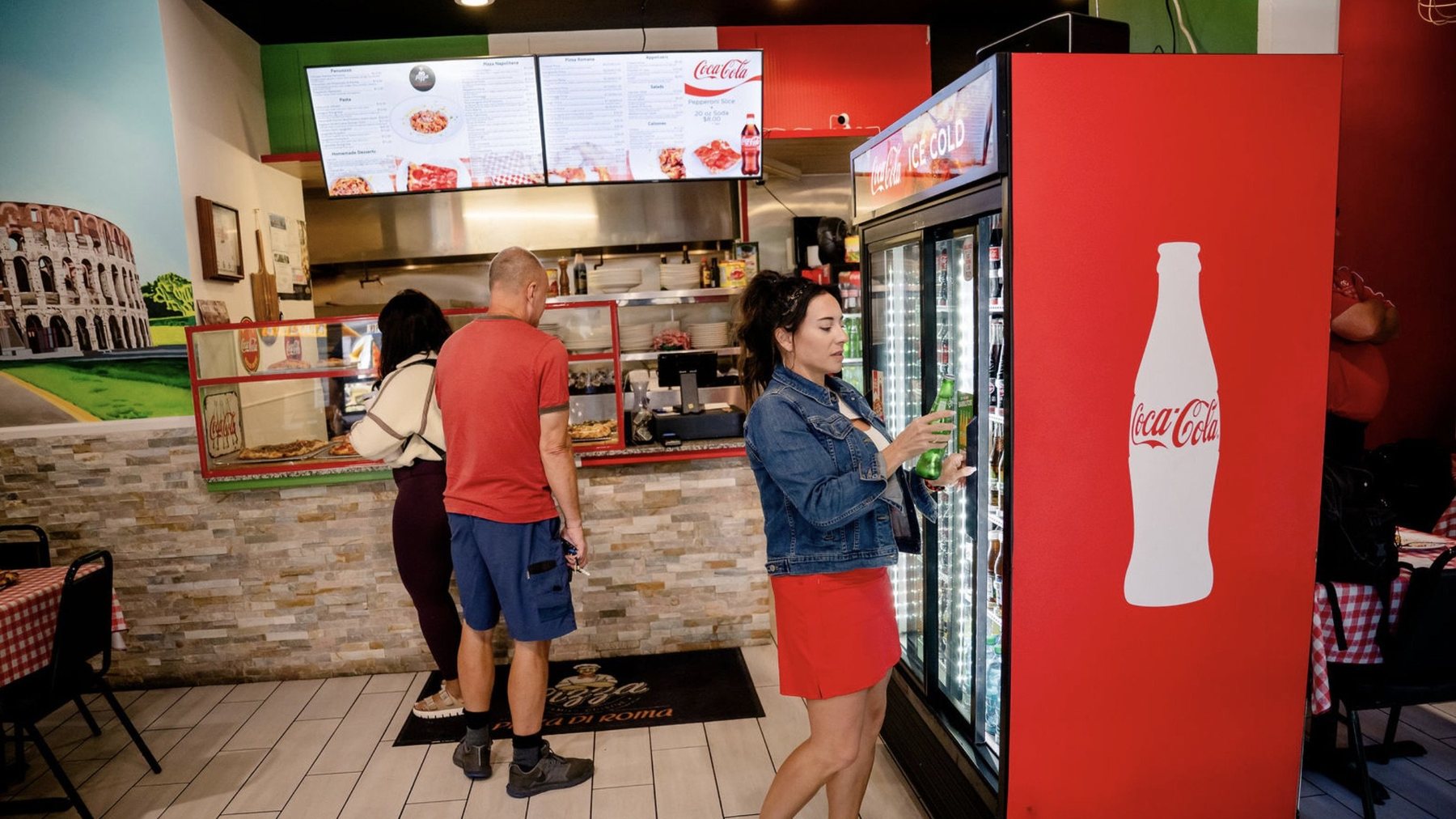 Guests ordering under the menu boards at Pizza Di Roma in Austin