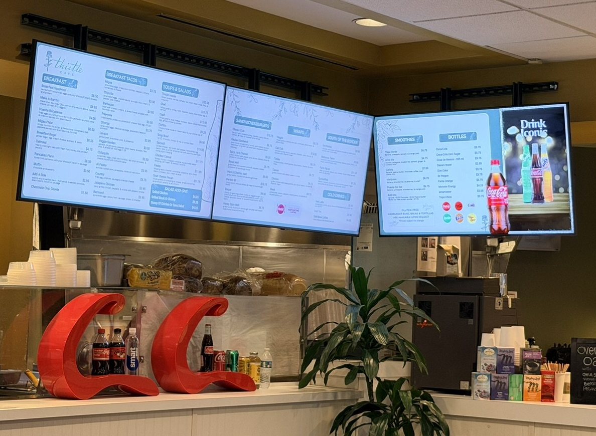 Three menu boards over the counter at Thistle Cafe in Austin, with breakfast, lunch and drinks
