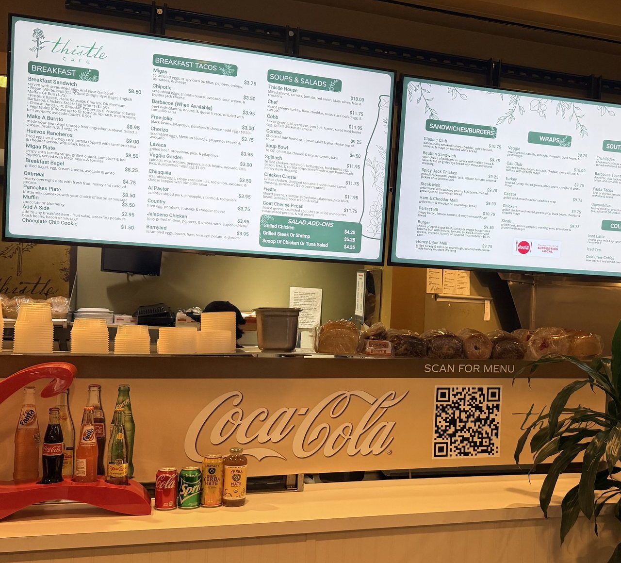 Menu boards at Thistle Cafe in Austin: breakfast, tacos, soups, salads, sandwiches, and a Scan for menu QR code below