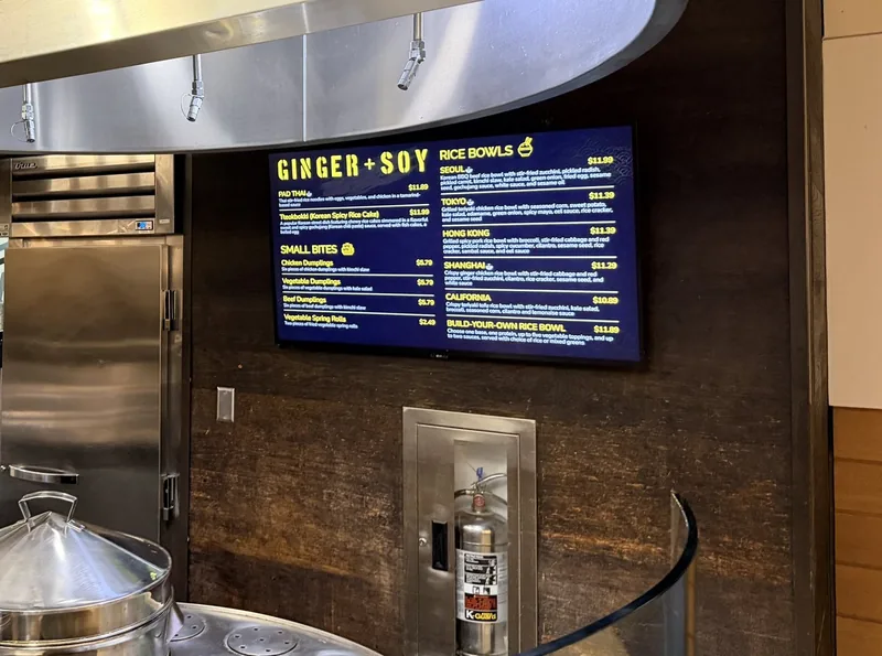 The Ginger + Soy menu board at Duke University dining, with rice bowls and small bites, above the steamers