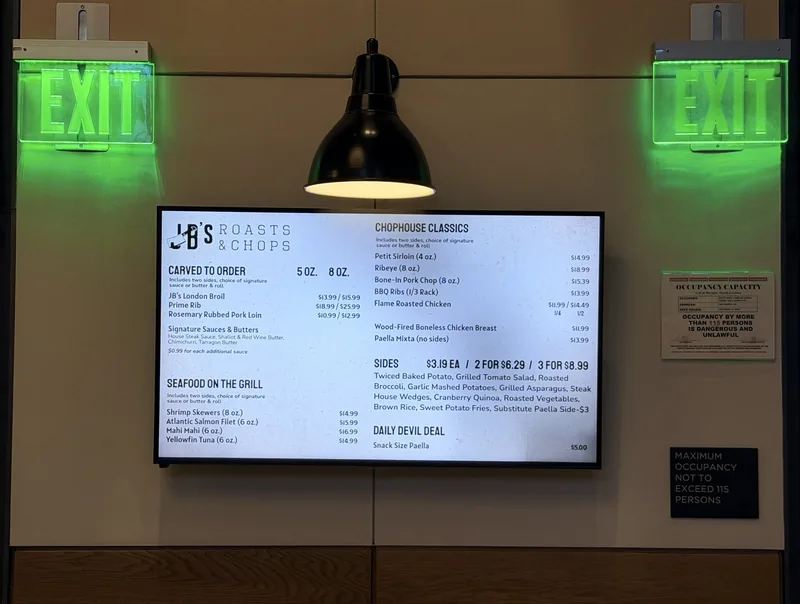 Roasts and Chops menu board at Duke University dining: carved to order, seafood on the grill, chophouse classics, sides
