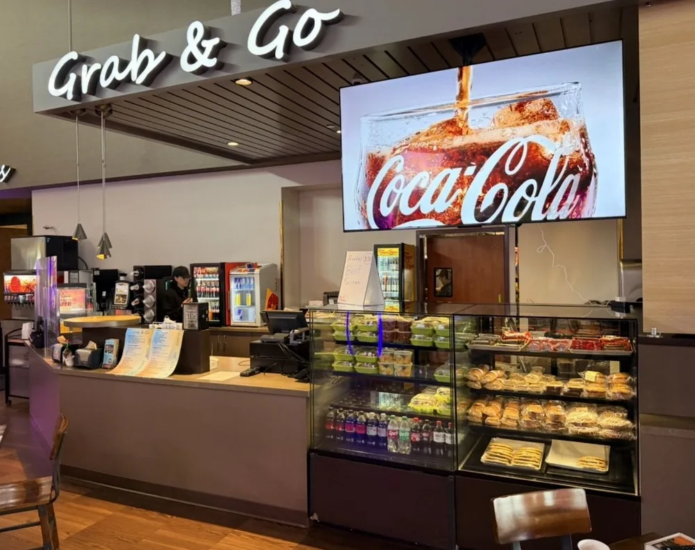 The same casino grab and go with a full-screen drink promotion playing between menu pages