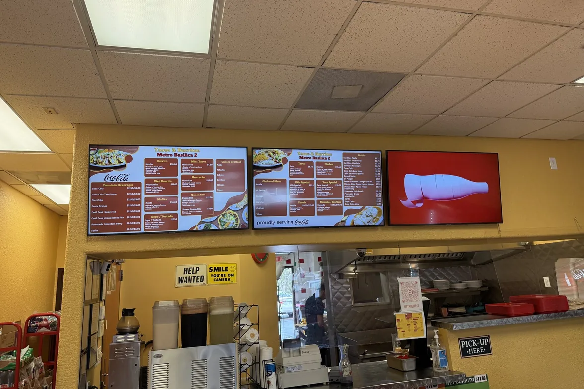 Three menu boards over the counter at Tacos & Burritos Metro Basilica 2 in Phoenix: two menus, one drink promotion