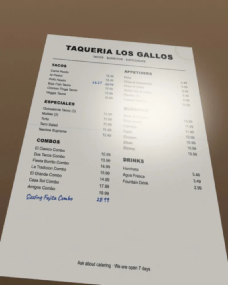 A poor menu photo: taken at an angle, with glare across the prices and part of the page cut off
