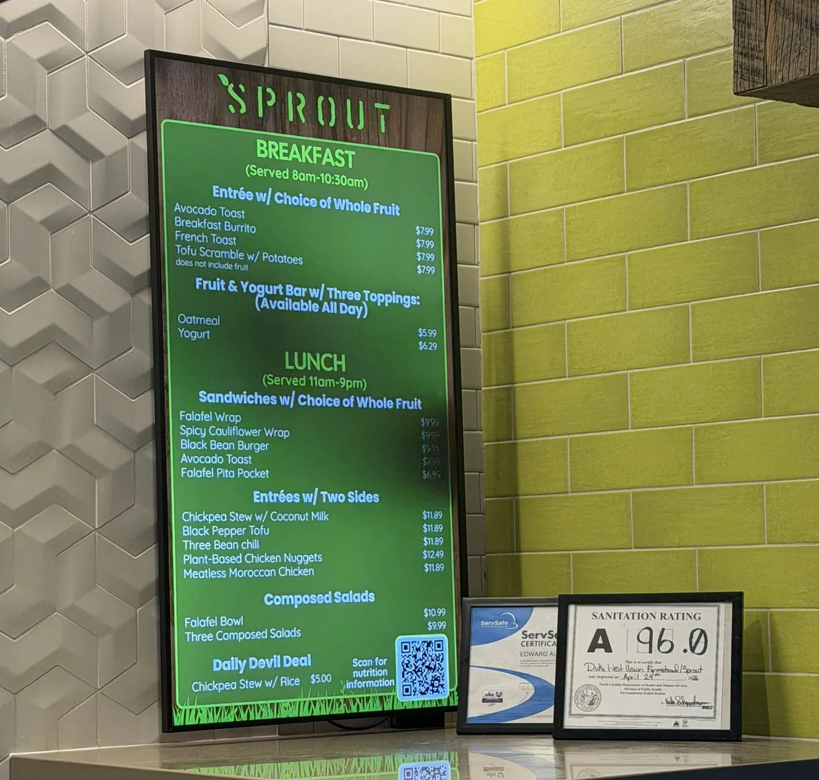 Sprout's tall green menu board at Duke University dining, with Breakfast and Lunch sections and a nutrition QR code