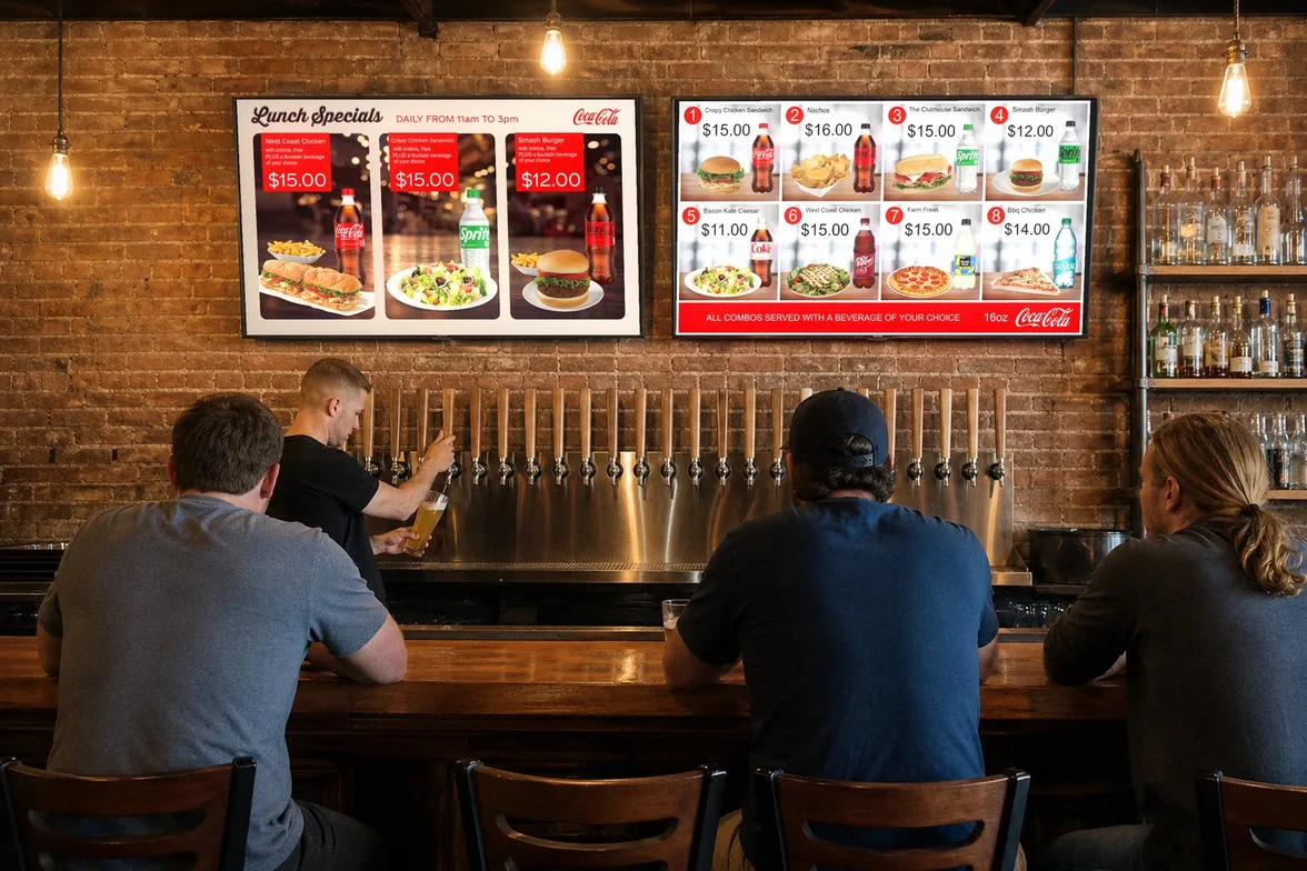 Illustration of a bar: two TVs over the beer taps show real Just a Menu boards, lunch specials and eight numbered combos
