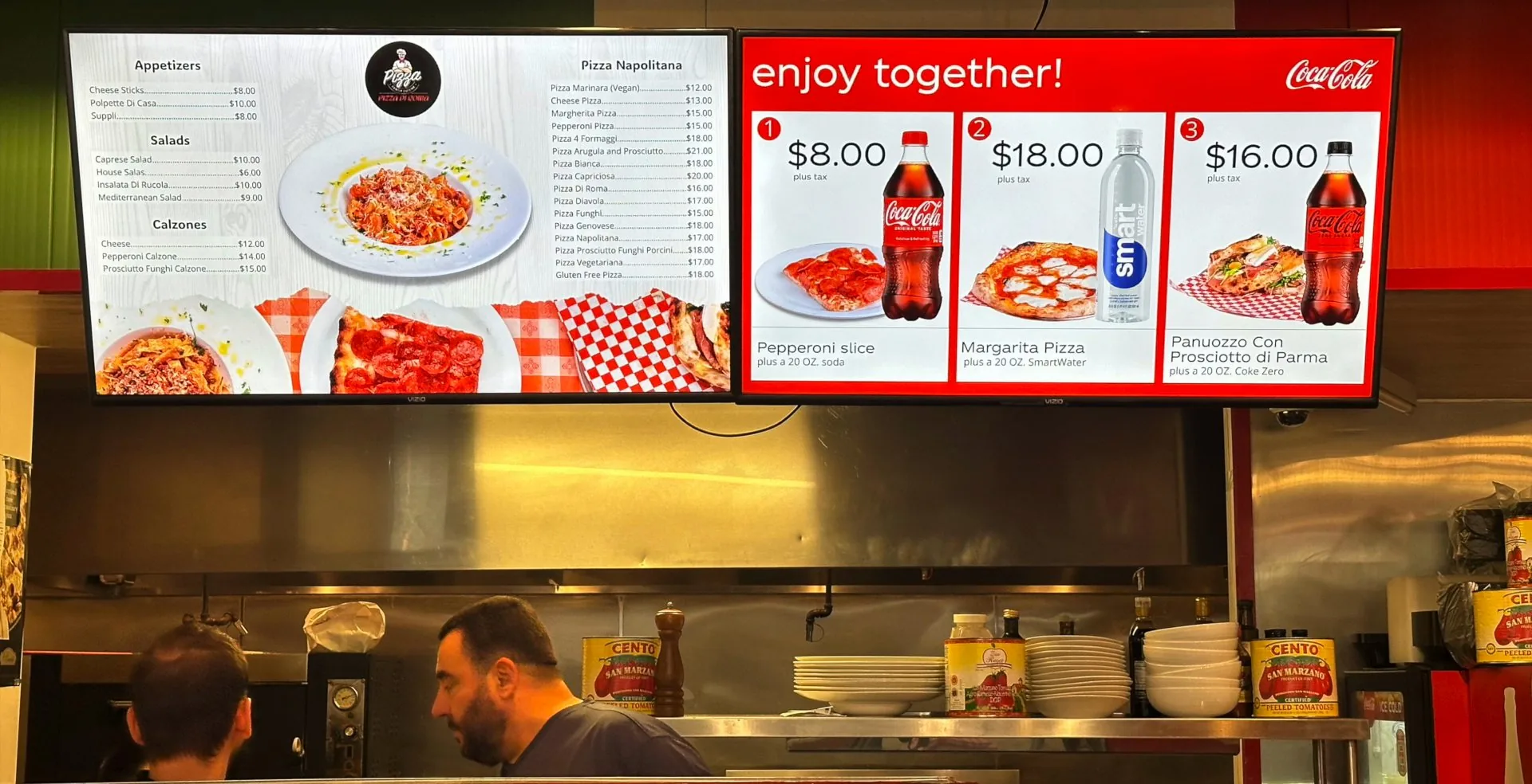 Two menu boards at Pizza Di Roma in Austin: the full menu on the left and a drink combo screen on the right
