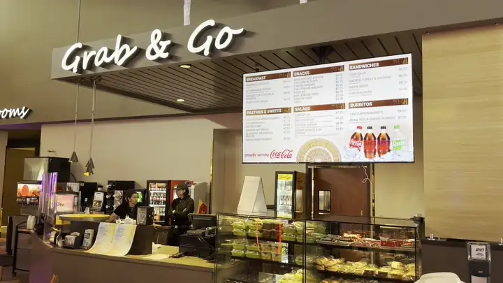 After: the menu board over a casino grab and go counter, rotating with drink promotions
