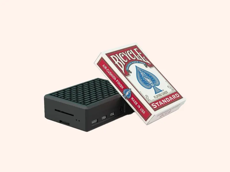 A JAM Player next to a pack of playing cards, for size