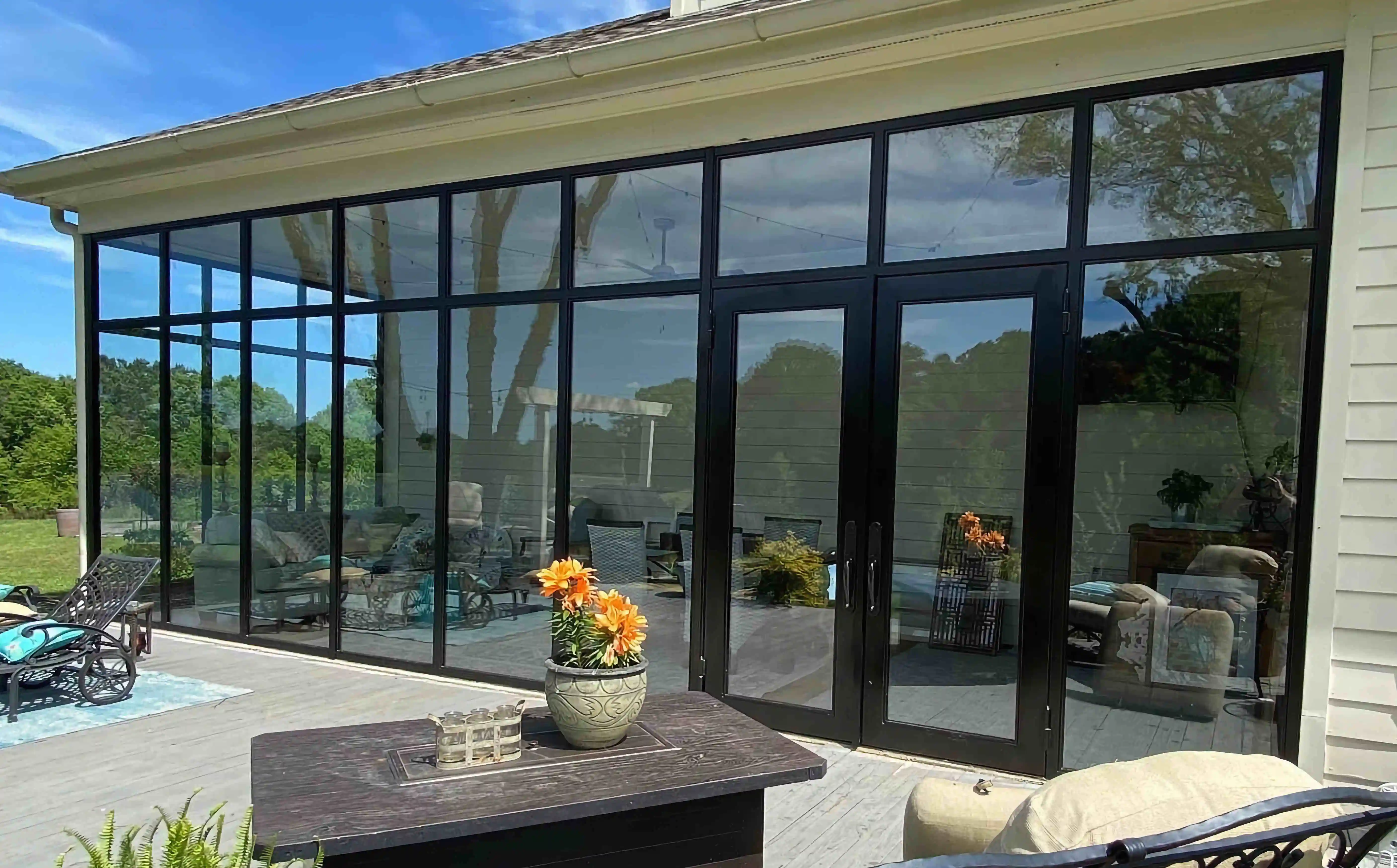 a home viewed from the back with the entire back being a large glass wall