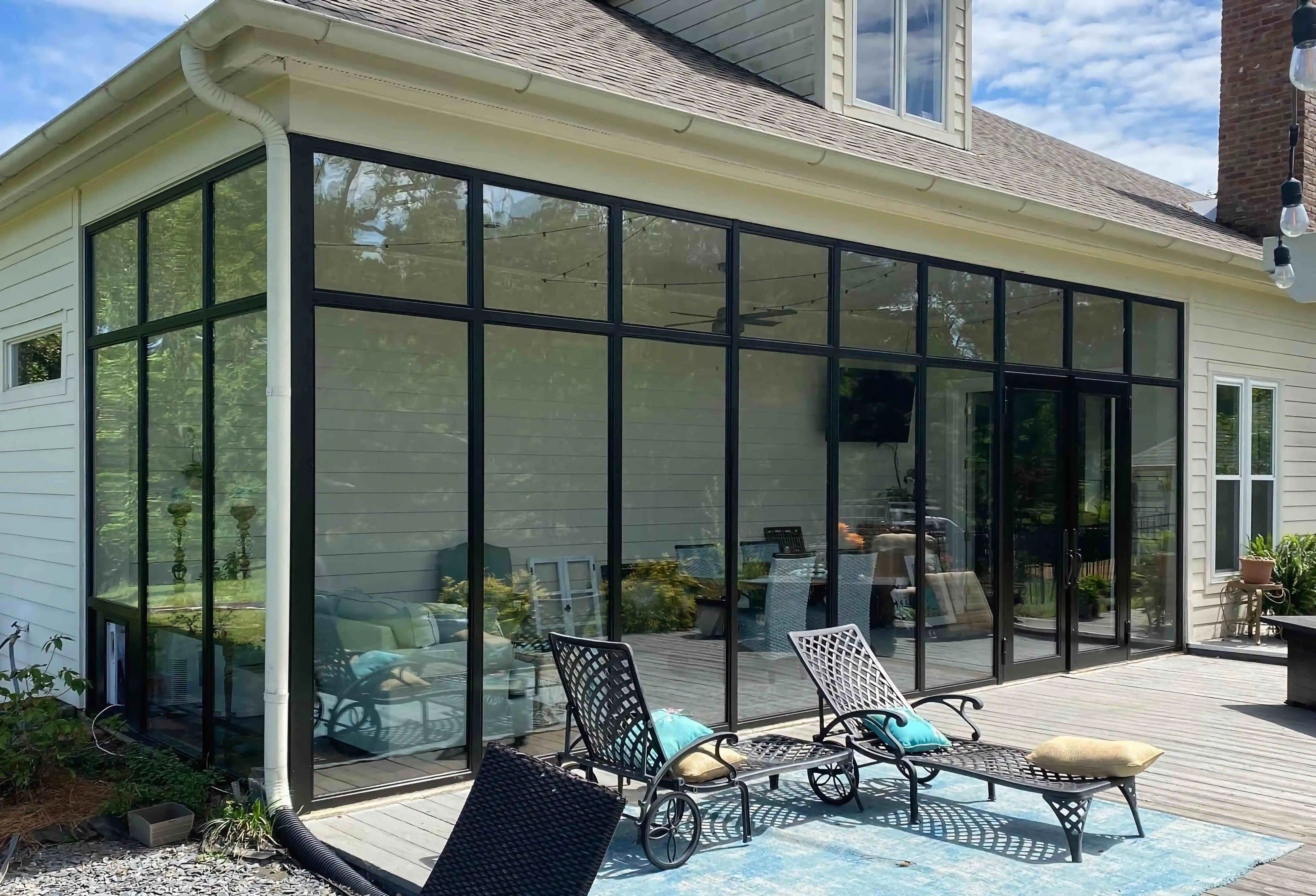 a home viewed from the back with the entire back being a large glass wall