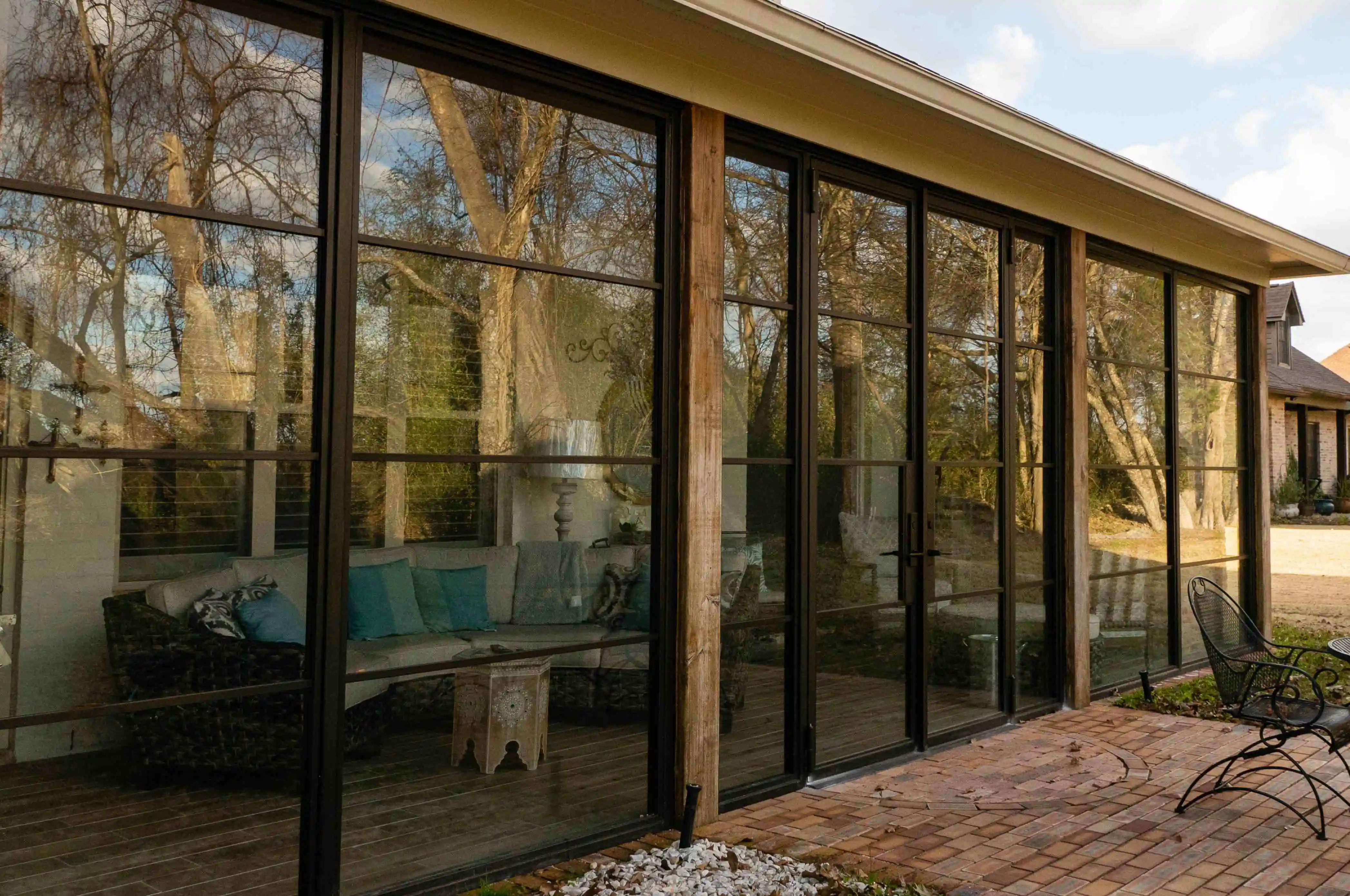 large glass walls, enclosing back room facing yard