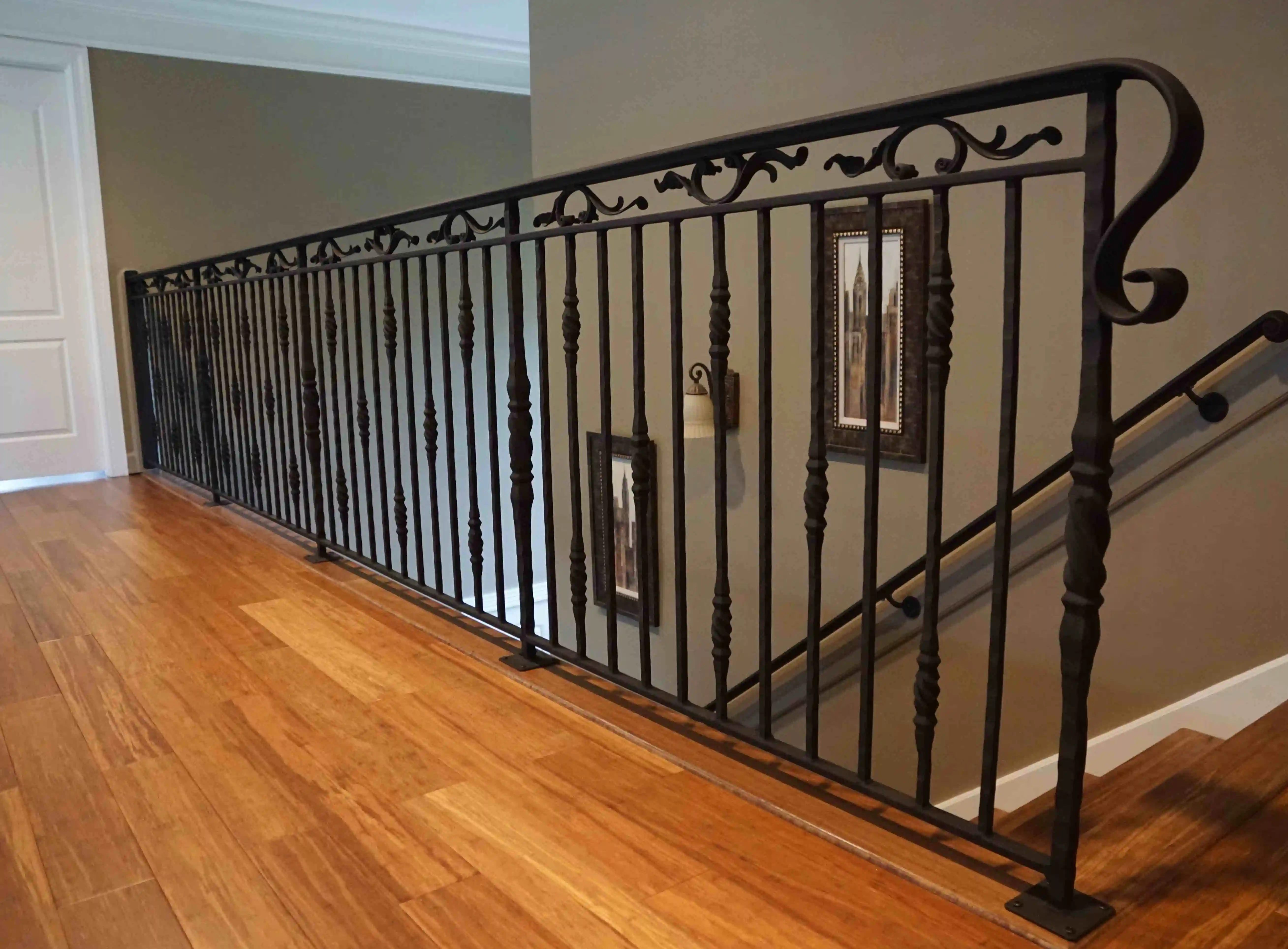 a close up of a black glossy iron railing inside of a home