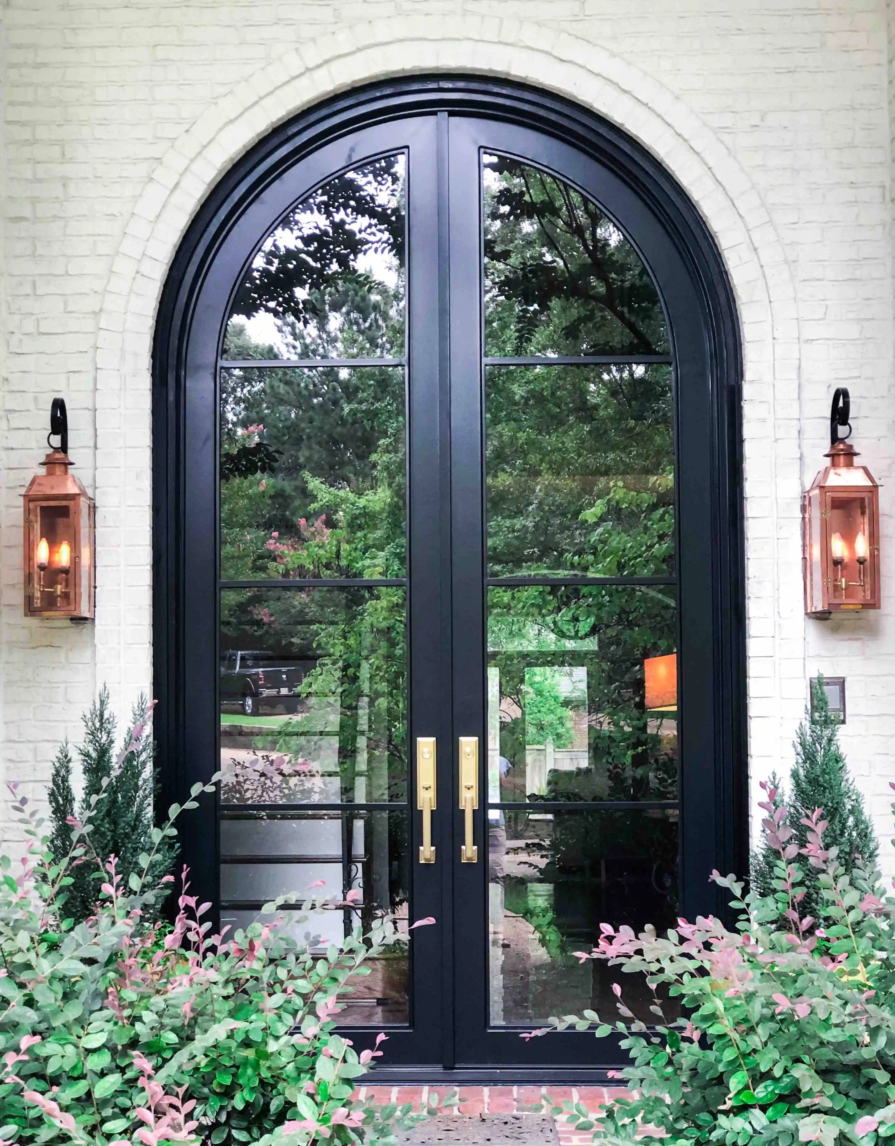 black iron front entry double door with 8 glass panels and rounded at the top