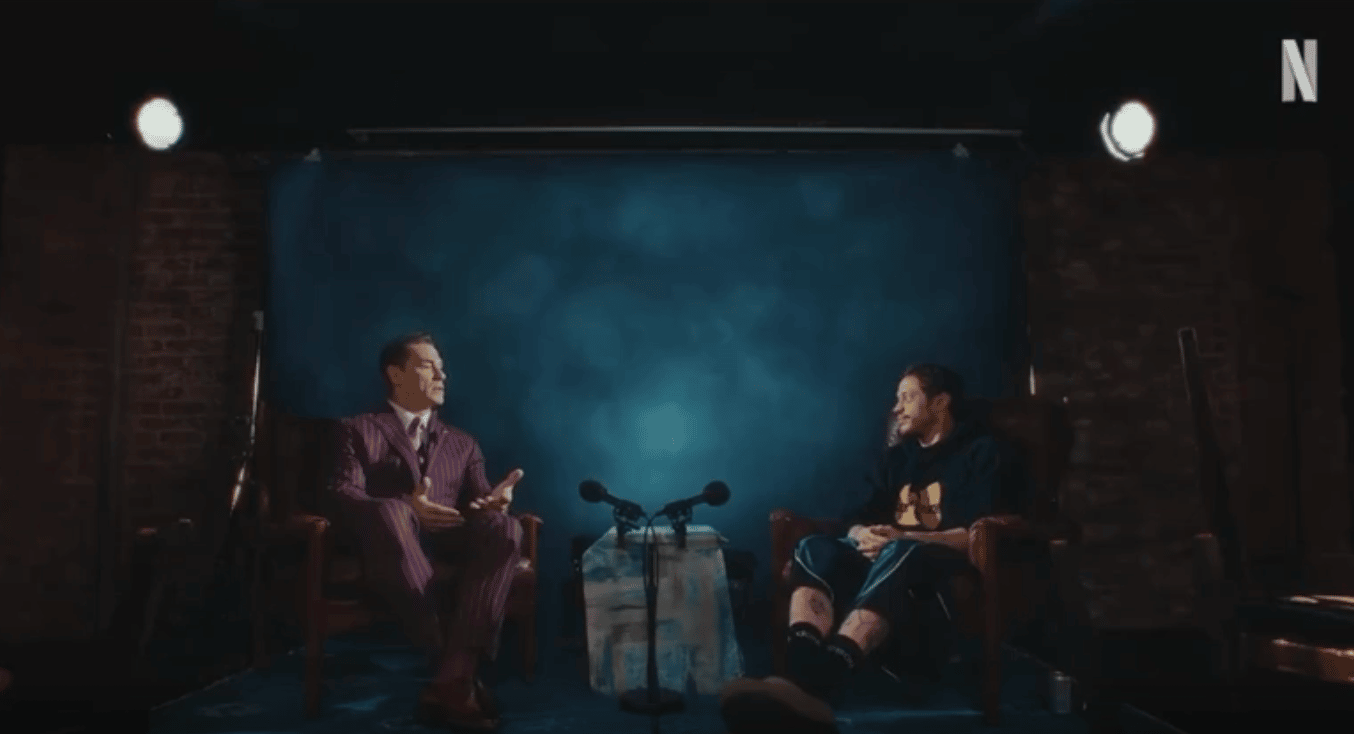 John Cena and Pete Davidson sitting on set in conversation about their work with the Make-A-Wish Foundation