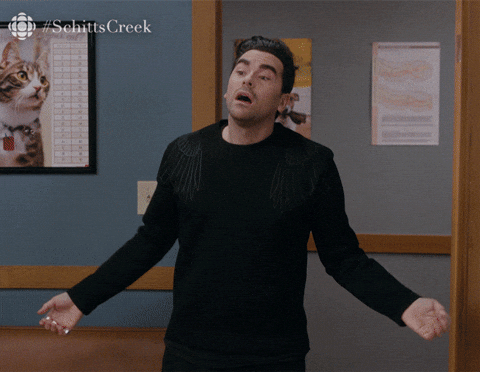 Animated GIF of David from Schitt's Creek entering a room and saying hey, it's me
