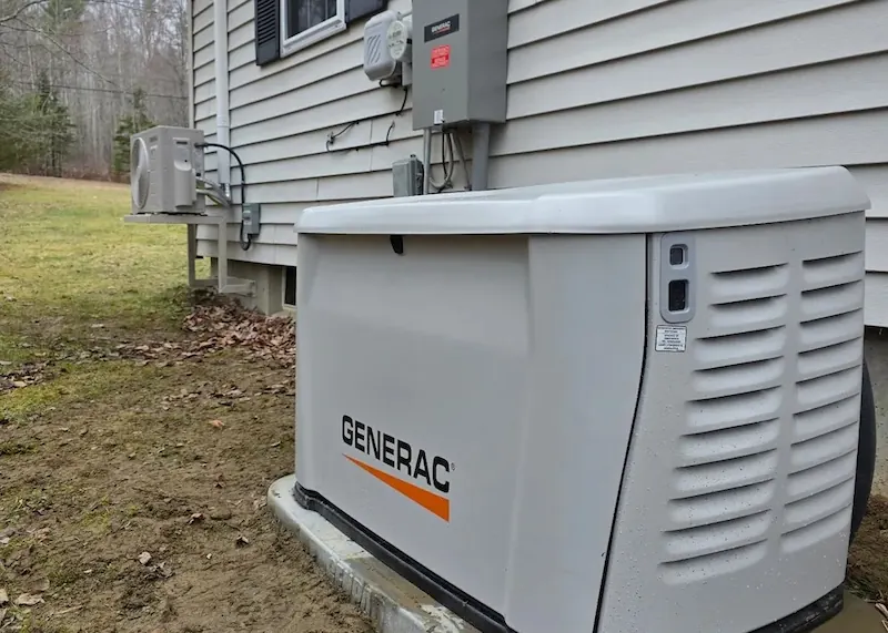 Generac home standby generator installed beside house siding on a concrete pad outdoors.