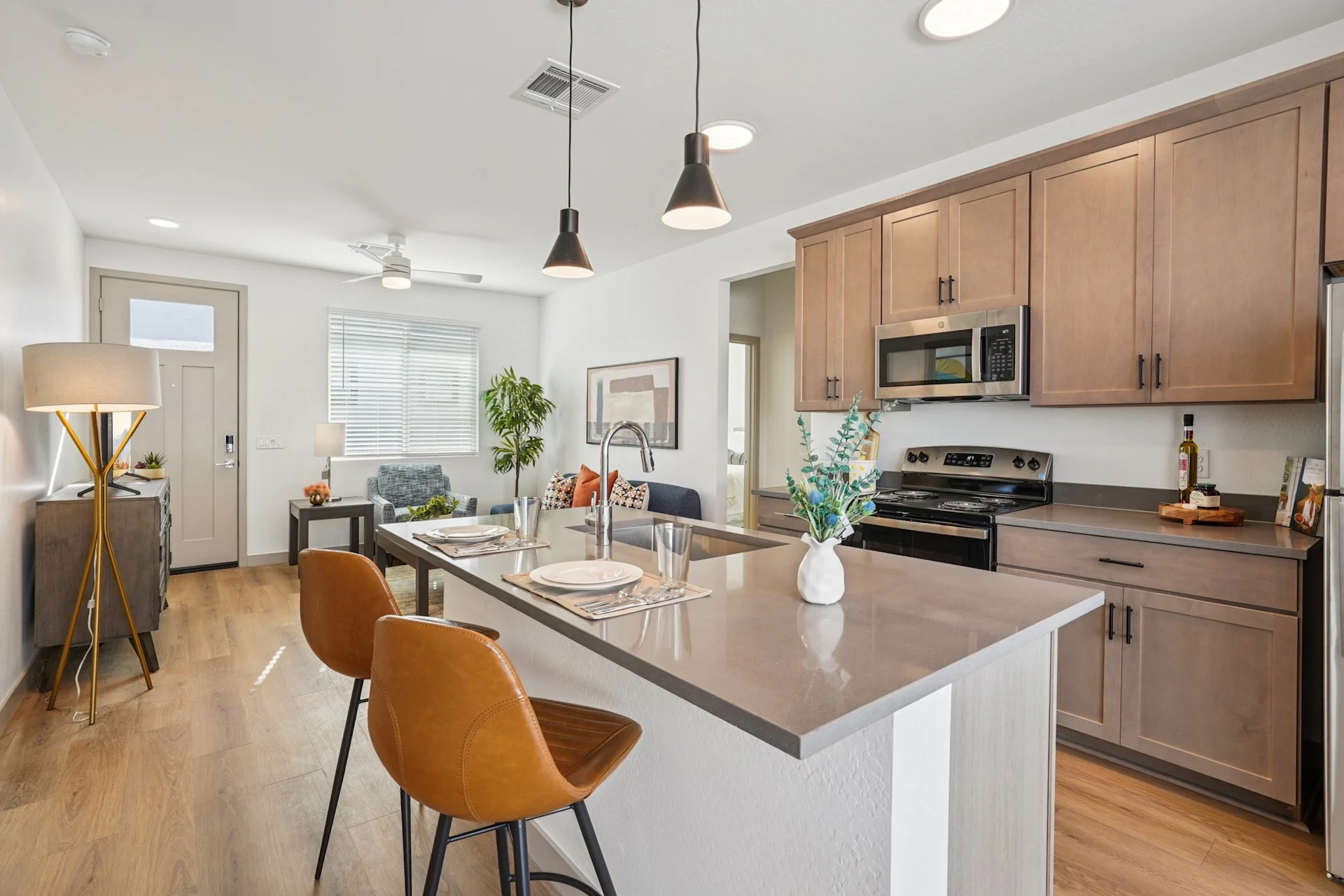 Wide view of kitchen with island and living area