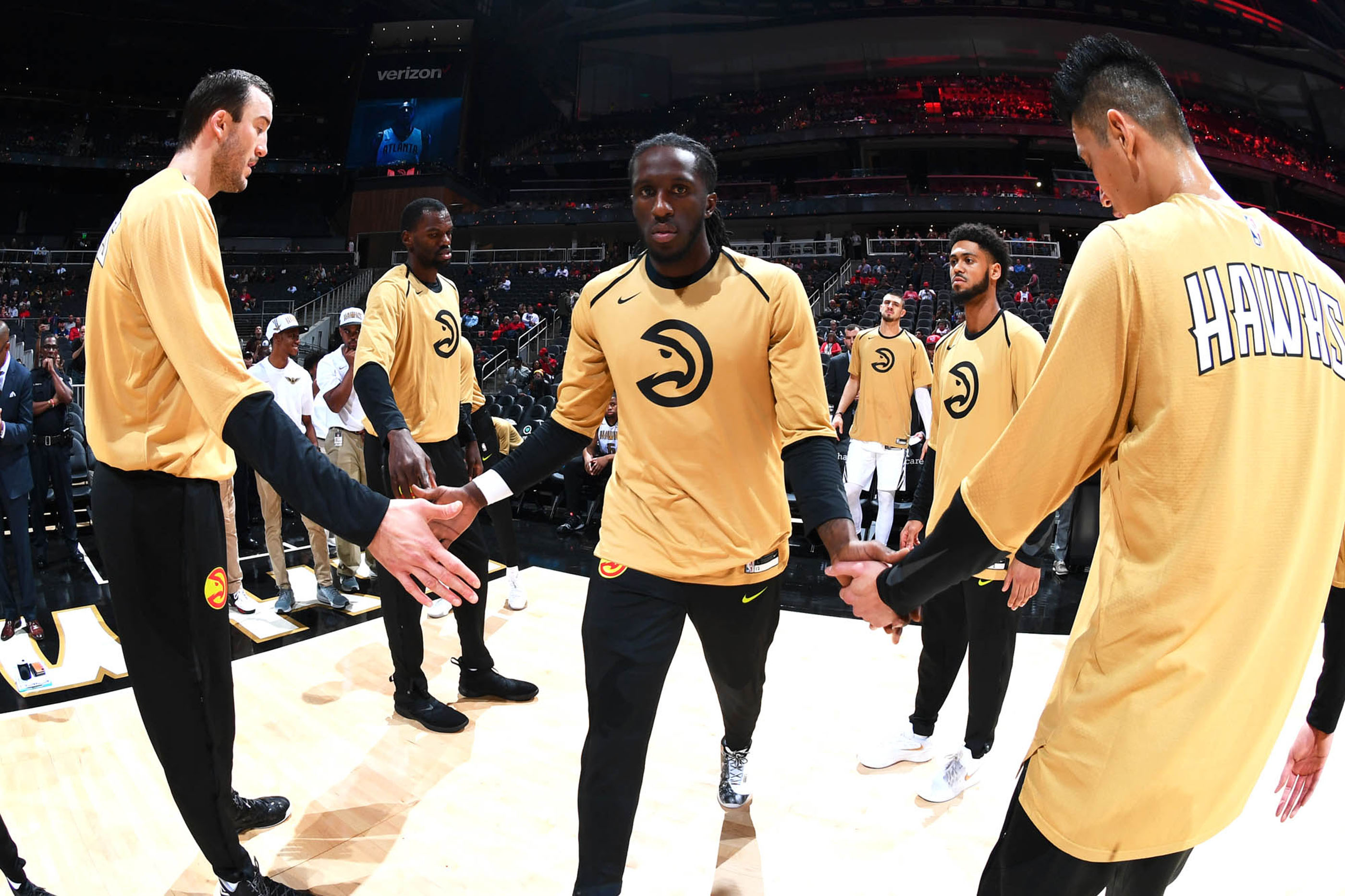 Tantrum Agency Hawks 50th anniversary campaign featuring an Atlanta Hawks player in gold warmups hyping teammates on court