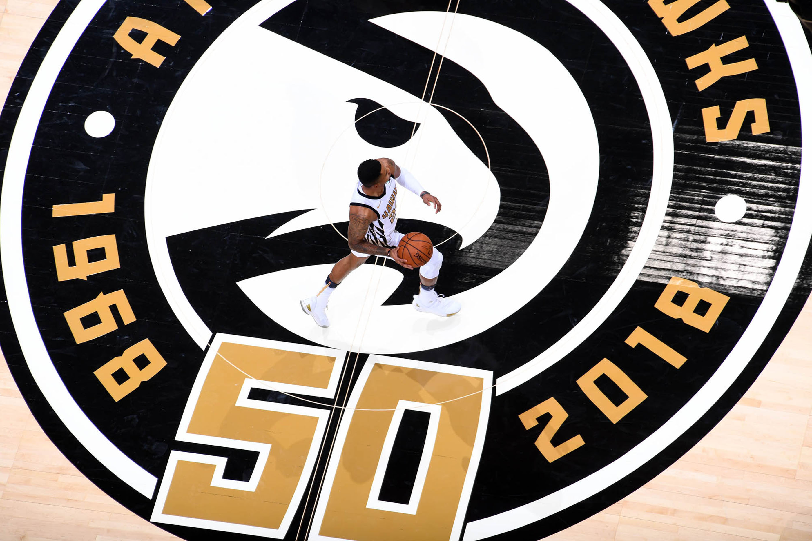 Tantrum Agency Atlanta Hawks 50th anniversary court graphics framing live basketball action at State Farm Arena