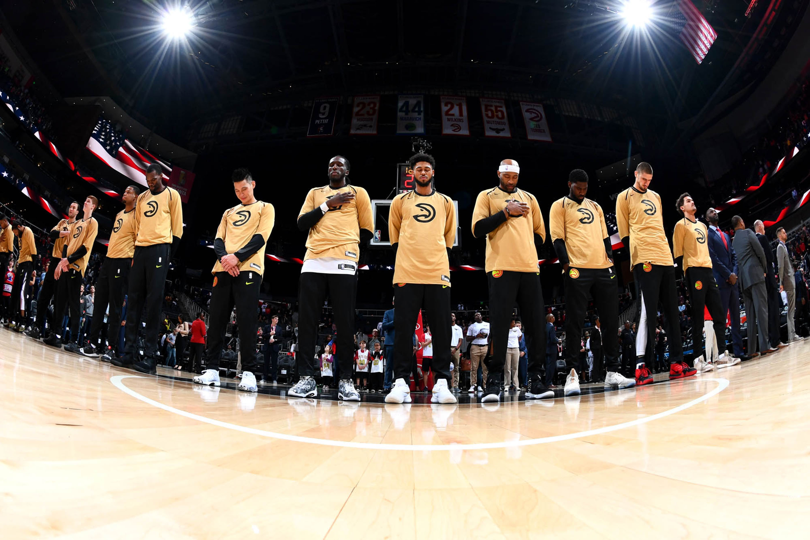 Tantrum Agency Hawks 50th anniversary branding for the Atlanta Hawks featuring players in gold anniversary warmups on court