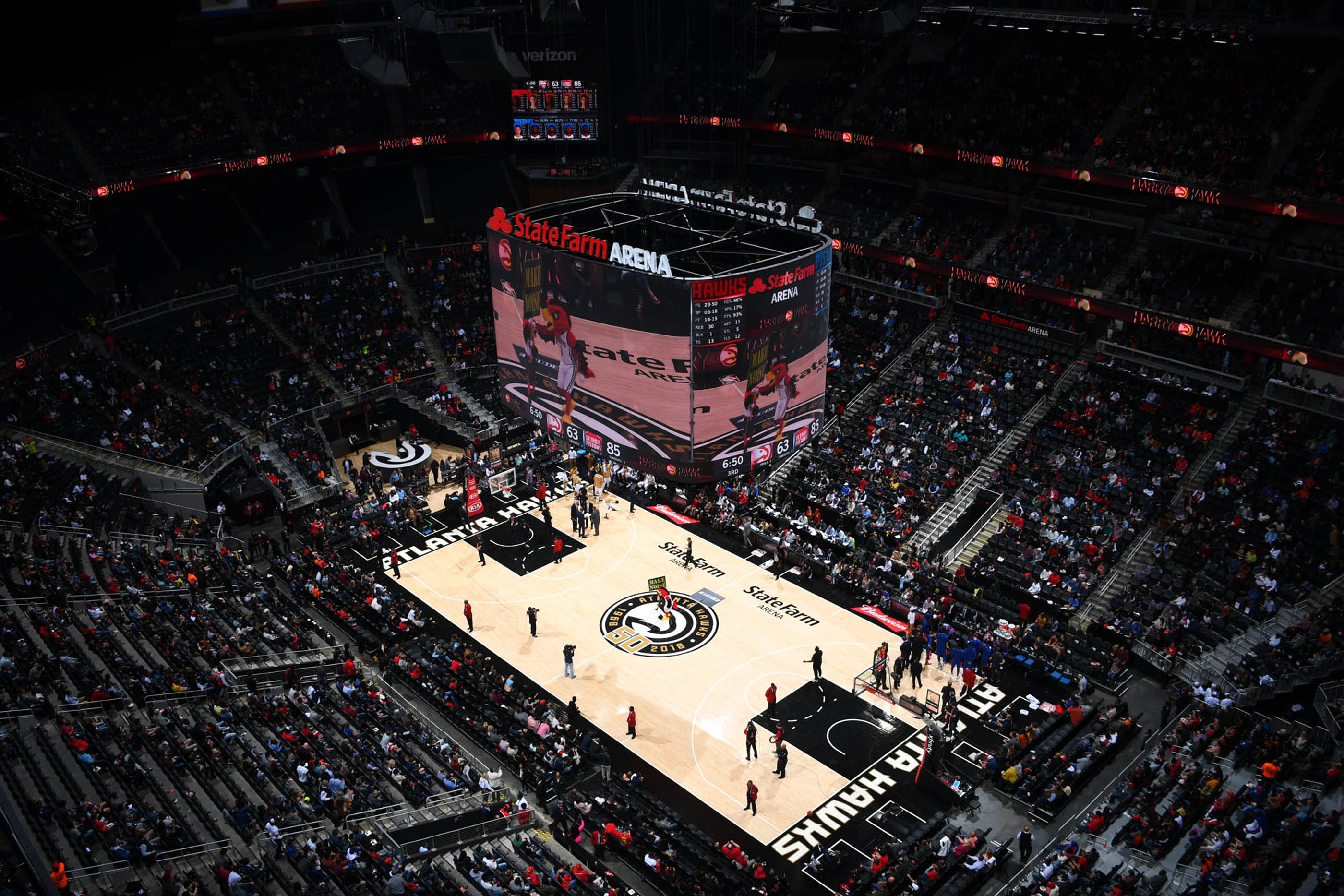 Tantrum Agency Hawks 50th anniversary branding displayed across the court and game-day environment at State Farm Arena