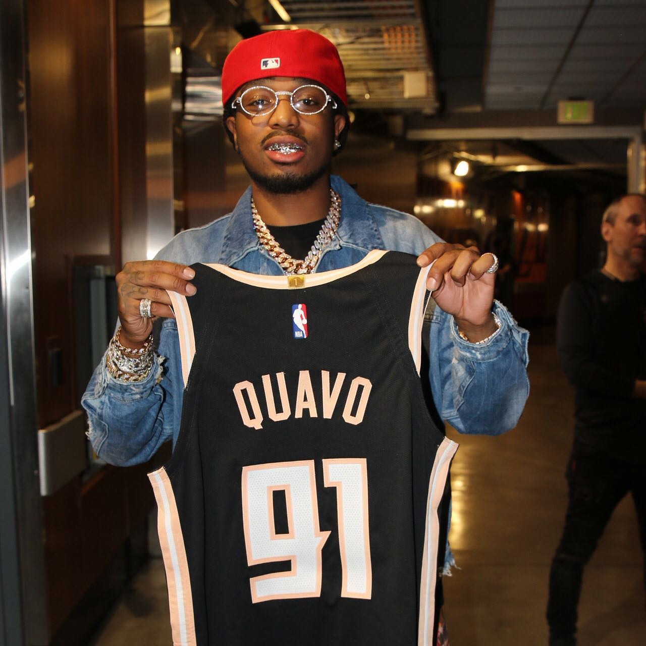 Quavo of Migos with his own personalized Atlanta Hawks Peachtree City Edition jersey featuring identity by Tantrum Agency shown 