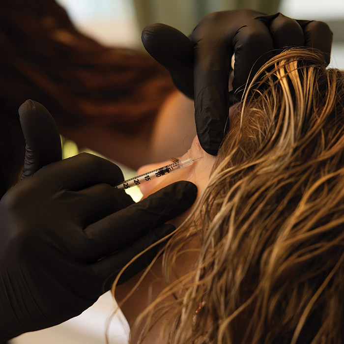 Kalli Freburg, PA-C, performing a cosmetic injectable treatment with precision at Envy Me Aesthetics.