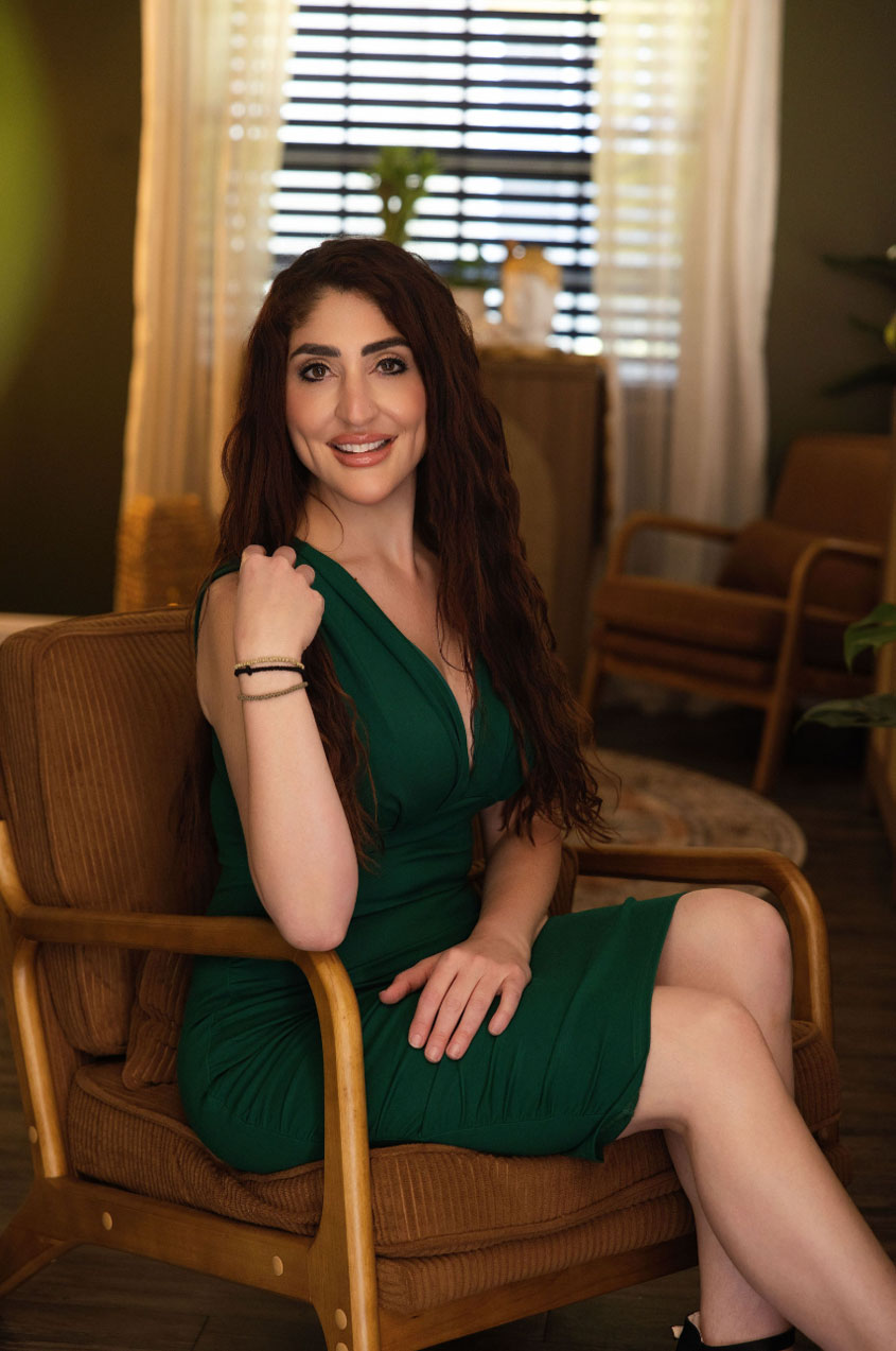 Kalli Freburg, PA-C, owner of Envy Me Aesthetics, seated in her aesthetic practice.