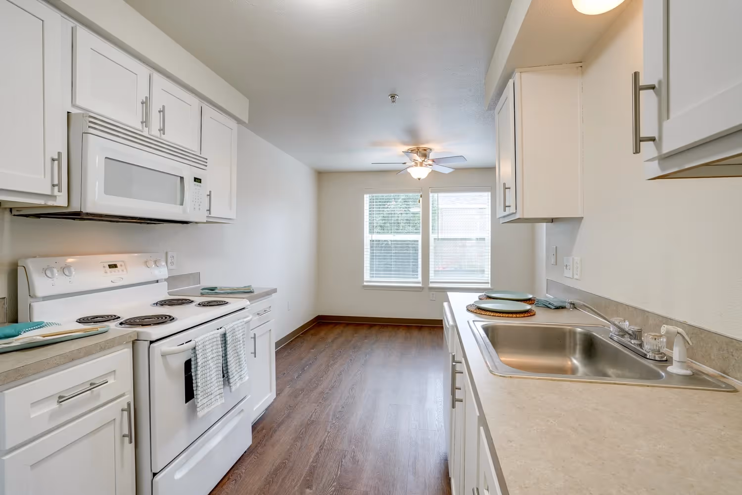 Kitchen with white cabinets and white appliances