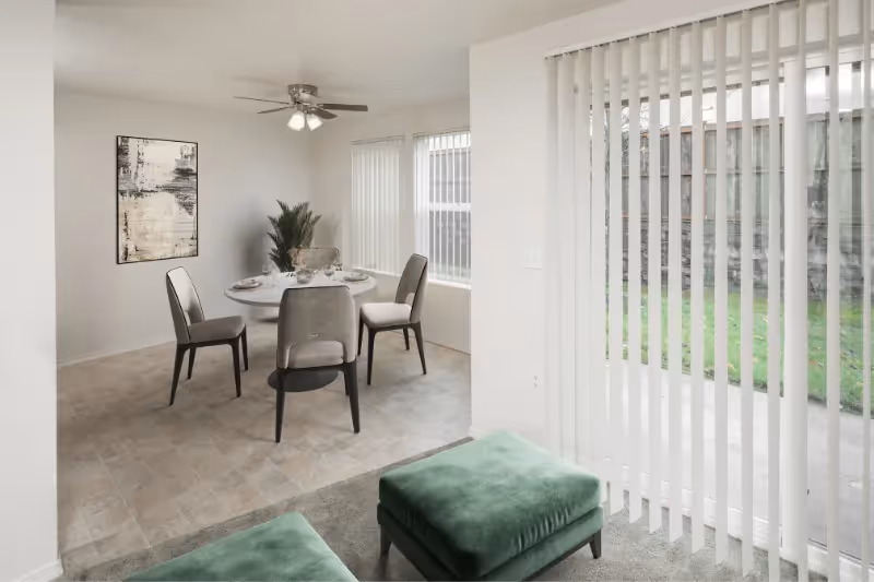 Virtually staged living area with view of dining area with table and chairs