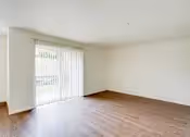 Unfurnished Living area with view of balcony entrance