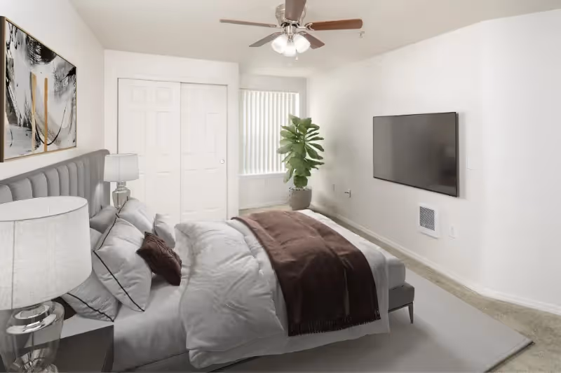Virtually staged bedroom with bed, tv, ceiling fan, and large window