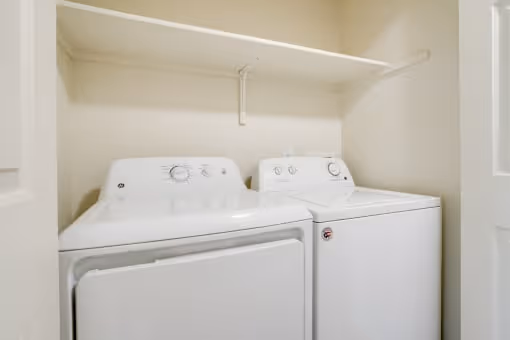Laundry room with white appliances