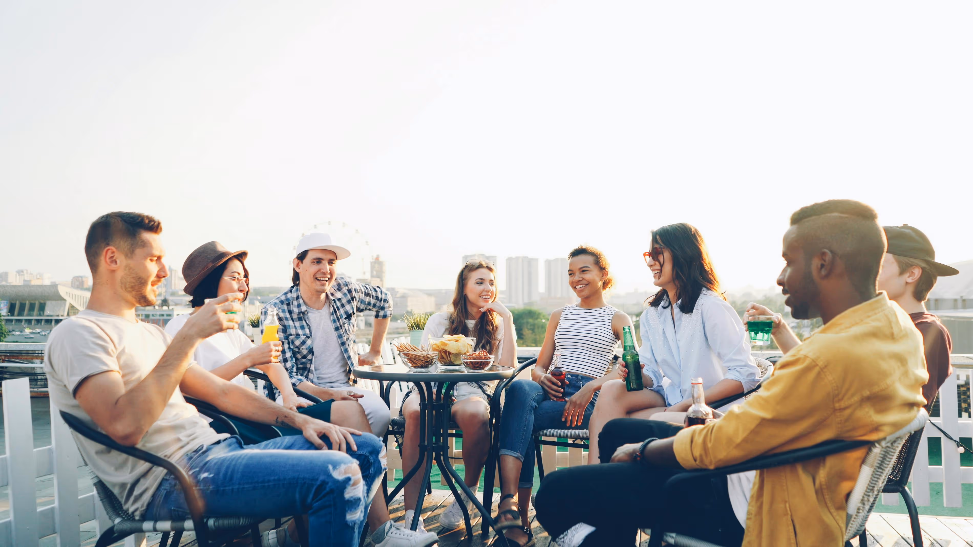 Friends gathered with drinks chatting stock photo
