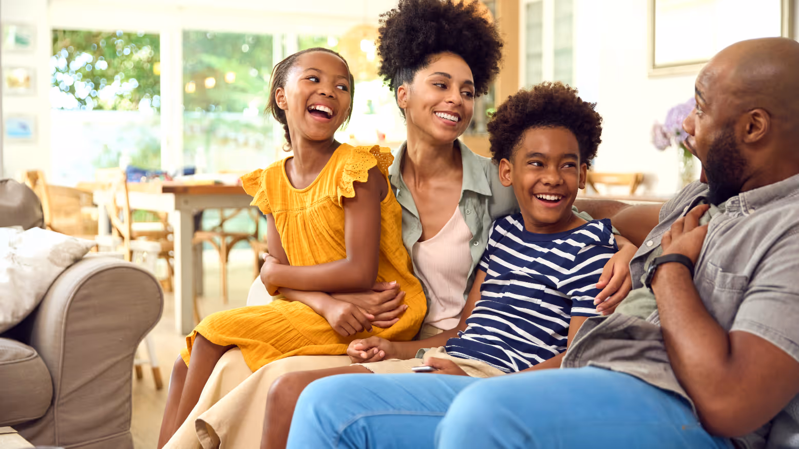 Family smiling on sofa stock image