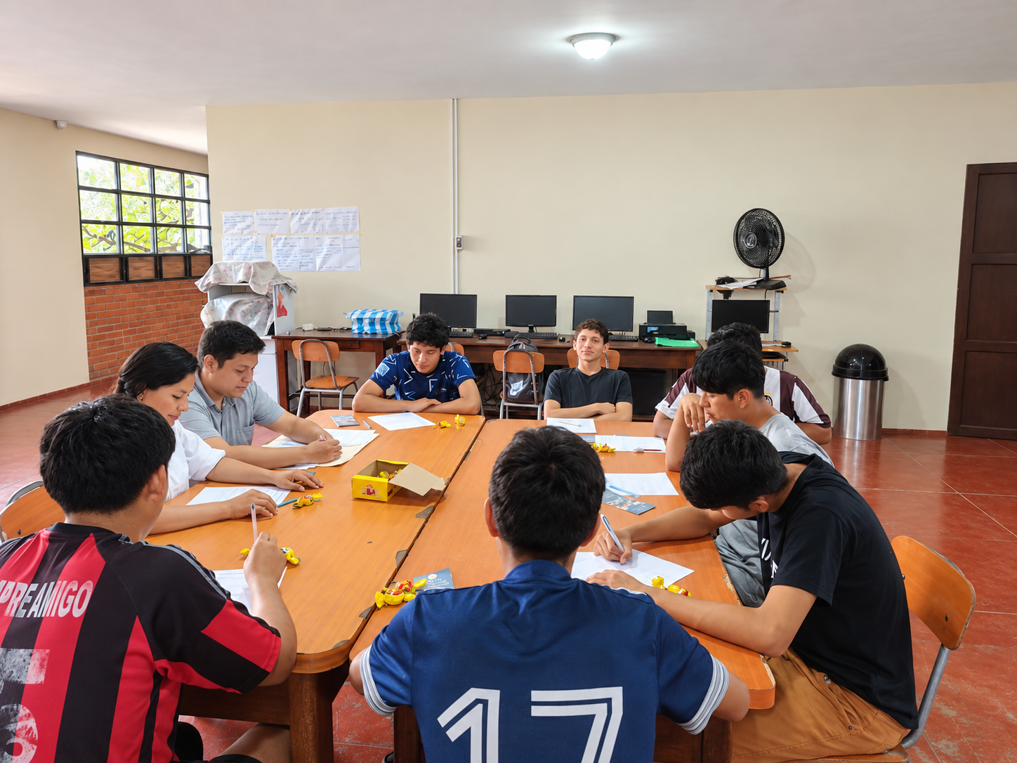 Young people working on an activity together around a table.