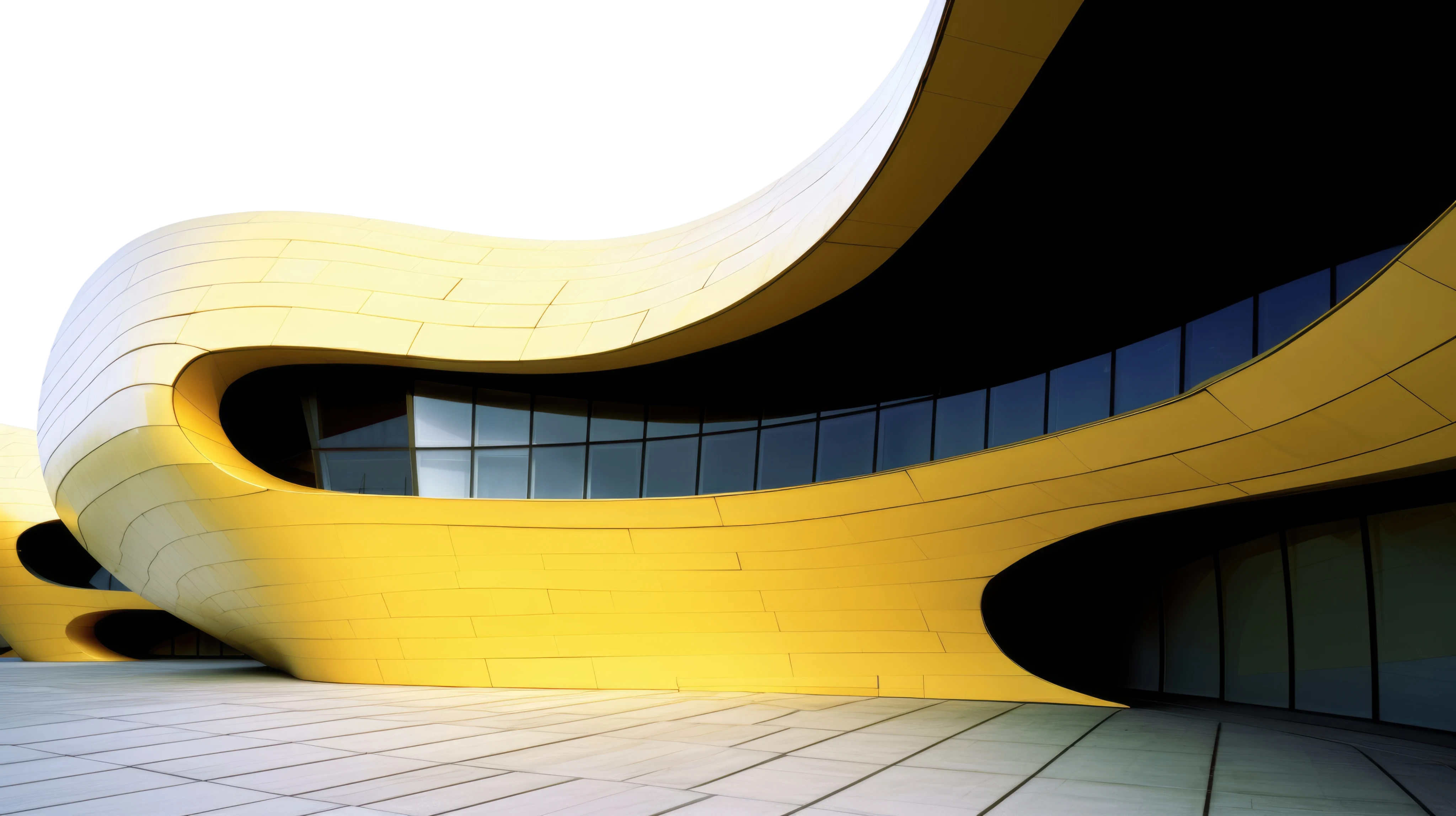 Curved modern building with smooth yellow panels and large dark windows.