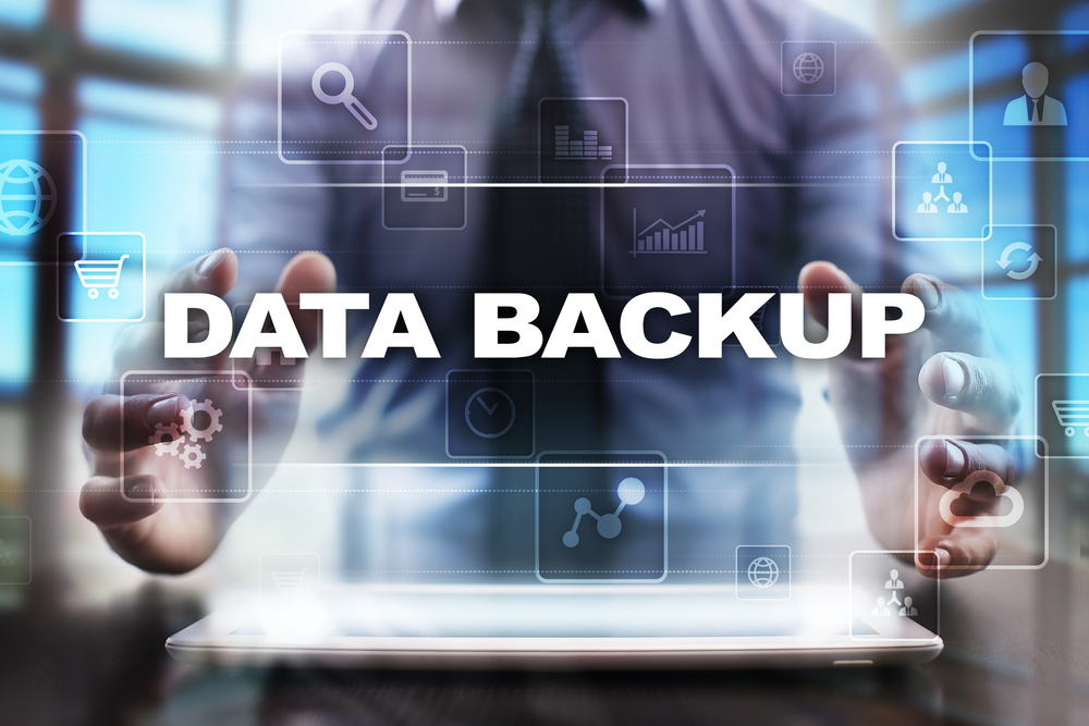 Businessman using tablet pc and selecting data backup.
